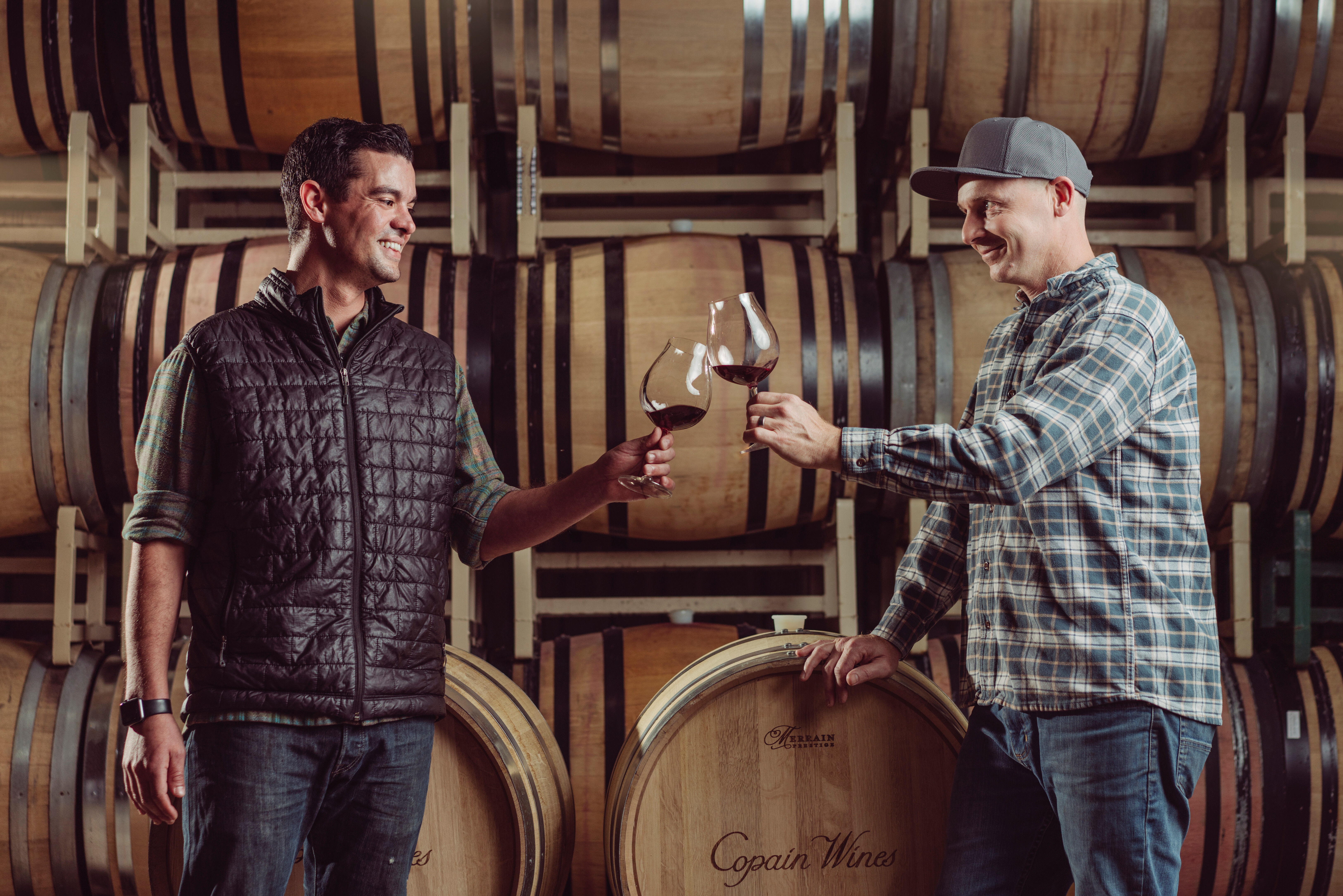 Winemakers Ryan and Quin cheers wine glasses