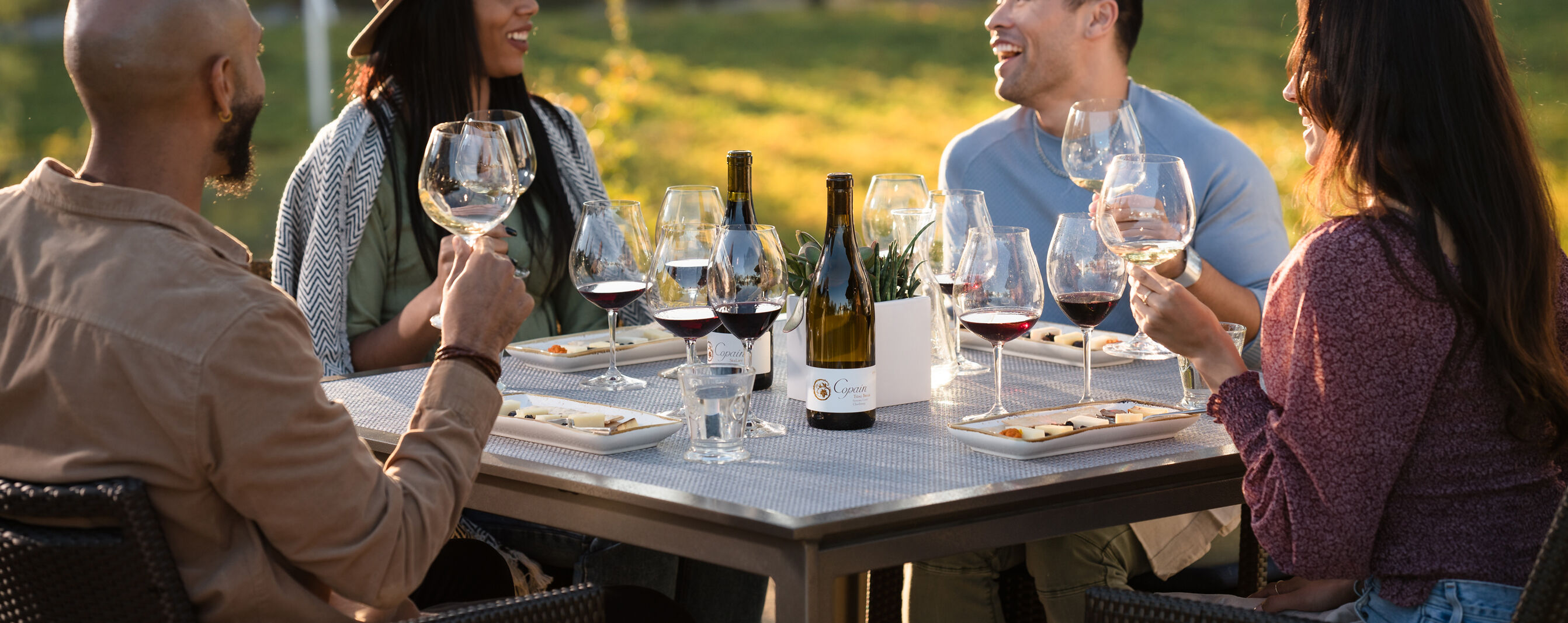 Overview of four at a table during a Copain Wines tasting.