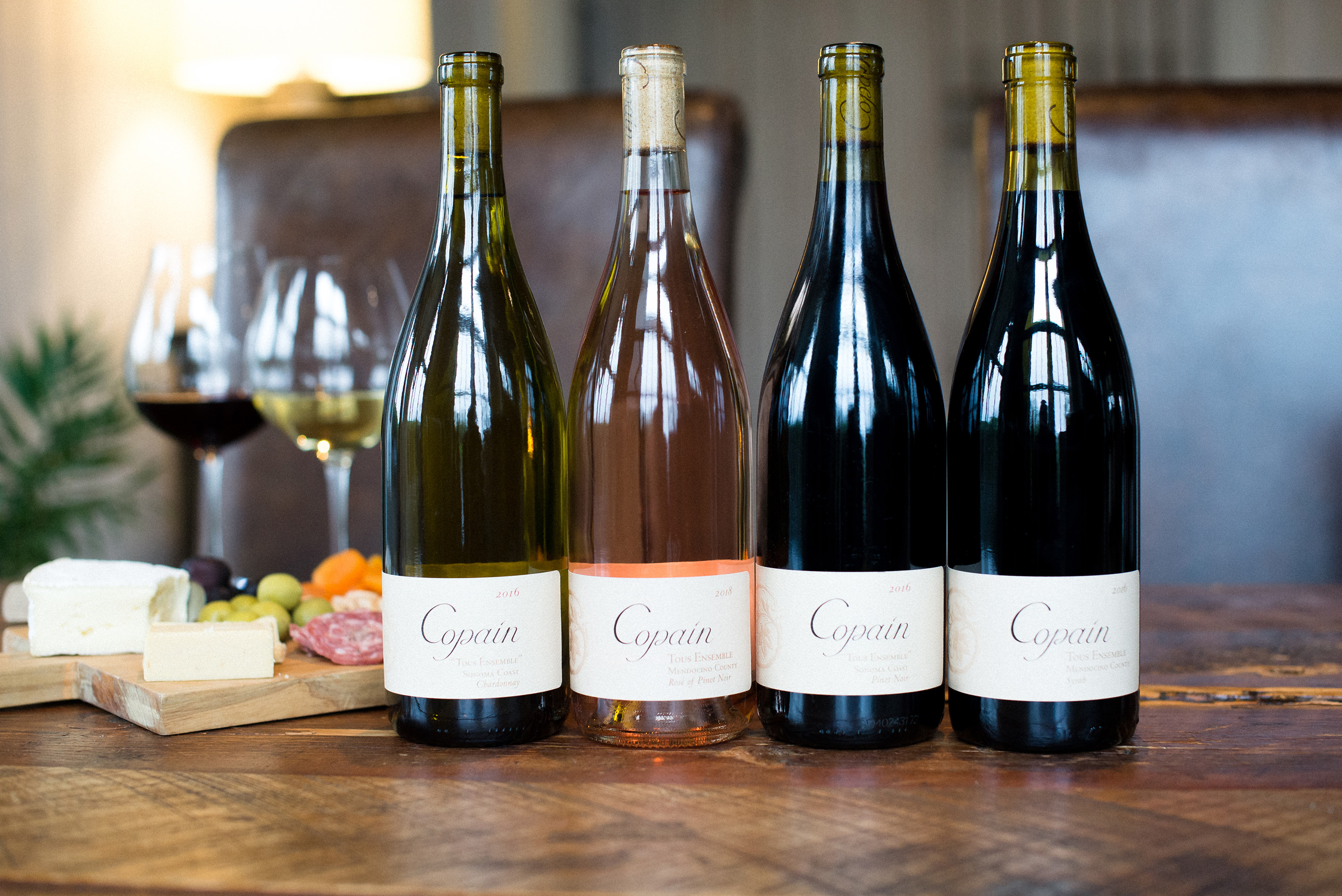 Four bottles of Copain wine standing side by side.